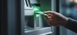 © Dmy - The ATM machine in use with a card being inserted for transaction.