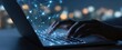 © Natallli - The laptop softly glows while hands type and data connections emerge.