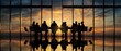 © Ruslana - The silhouettes of business professionals in a sunset meeting at a corporate office.
