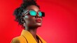 © Larisa AI - A striking portrait of a fashionable woman wearing sunglasses, showcasing bold colors and a confident pose against a vibrant red backdrop that highlights her beauty.