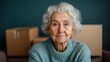 © Larisa AI - An elderly woman with curly hair sits thoughtfully in a cozy space, surrounded by cardboard boxes, representing a moment of reflection on life changes and transitions.