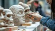 © Sudarat - Artist Sculpting Clay Facial Features in Creative Workshop Setting