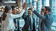 © Nutwara - Team Spirit in the Workplace: A group of diverse business people celebrate a success with high five in the modern workplace. Capturing the essence of collaborative achievement and camaraderie.