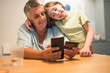© Victoria - Smiling caucasian grandmother and granddaughter enjoying time together with smartphone.