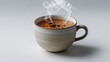 © Ali Khan - A steaming cup of spiced tea with cinnamon sticks and star anise on a white surface in a studio shot