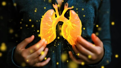 Wall Mural - man in blue clothes holding holographic image of golden lungs with glowing particles