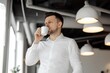 © Rosshahizal Amri - Businessman in White Shirt Enjoys Coffee in Modern Office Space