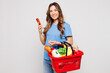 © ViDi Studio - Young woman wears blue t-shirt casual clothes hold basket bag for takeaway mock up with food products use mobile cell phone isolated on plain white background Delivery service from shop or restaurant