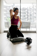 © ADDICTIVE STOCK - Woman training at home with fitness equipment