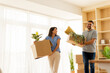 © BGStock72 - Two friends joyfully moving into their new apartment filled with light and greenery on a bright sunny day