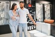 © Serhii - in a plumbing store, a man and woman chooses a new toilet bowl
