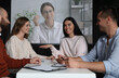 © New Africa - Group of people participating in business conference indoors. Speaker on projection screen