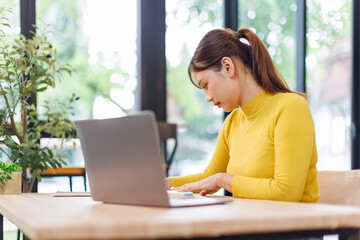 portrait of a freelancer woman working on laptop computer. beautiful asian woman working in a workpl