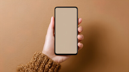 Wall Mural - hand holding smartphone mockup with blank screen on brown background