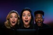 © Pippin - Diverse Group, Three Young people Reacting with Shock, Awe, Curiosity to Digital Content on a Glowing Screen, Dark Room. Colorful Lighting. Collaborating in a Strategic Planning, Brainstorming Session