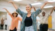 © Aleksandr S - A certified dancemovement therapist leads a vibrant dance session, encouraging participants to express themselves through movement in a bright studio setting during an afternoon workshop