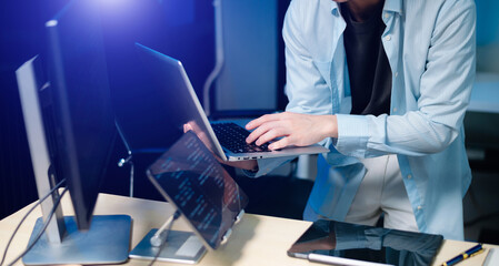 male programmer using stylus to analyze code on tablet and monitor. software development, coding, an