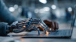 © Muslima - Robotic hand typing on a laptop keyboard in a bright room.