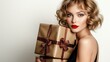 © mashimara - Glamorous Gift: A stunning woman with a chic bob haircut and bright red lipstick holds two elegant, gold-wrapped gifts, exuding sophistication and holiday cheer.