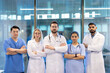 © Liubomir - A diverse medical team stands together, arms crossed, conveying unity and expertise in a modern healthcare setting.