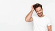 © Newleks - Young male model wearing white t shirt, running fingers through hair, standing confidently against white background with relaxed, casual demeanor
