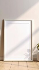 Wall Mural - bright interior room with an empty white picture frame and plant pot sitting on a light wood floor w