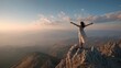 © CStock - A woman stands triumphantly on a mountain peak, embracing the beauty of nature around her during sunset.