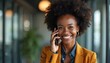 © Maryna - Joyful african american businesswoman smiles talking phone in modern office. Attractive woman wearing suit using mobile smartphone. Happy female, entrepreneur working, business pro, remote