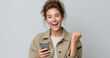 © Niks Ads - excited woman holding smartphone