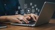 © Gogobie - Person using laptop with digital media icons online education technology internet communication work