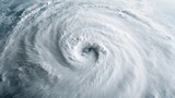 An aerial view of a swirling cyclone or hurricane over ocean waters, demonstrating the powerful forces of nature and displaying a spiral of clouds in dramatic motion.