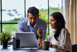 © StockImageFactory - Indian businessmen Working on laptop and reviewing project papers together at desk in indoor office