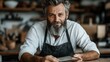 © Larisa AI - A skilled craftsman with a beard smiles while working in his cozy workshop, surrounded by various tools and materials, embodying creativity and craftsmanship.