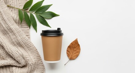 cozy autumn flat lay with coffee cup knit sweater and leaves