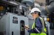 © JD Studio - Engineer inspects gas insulated switchgear equipment carefully while taking notes in industrial setting ensuring safety and functionality of electrical system