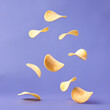 © LumaBay - Flying Potato Chips on Purple Background Crispy Snack Food Explosion