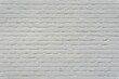 © Wirestock - A thick layer of white paint covers the brick wall