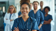 © Dmitrii - Portrait of happy young nurse in uniform with healthcare team in background