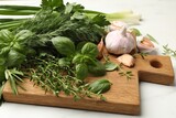 Different fresh herbs and spices on white table, closeup