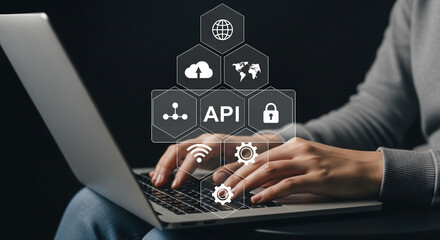 person typing on laptop with api and cloud computing icons overlayed on the screen interface
