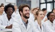 © hestywinarni - Smiling students in white coats attentively listen in a welllit classroom