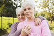 © Raisa Kanareva - Two elderly twins hugging on a summer day in the park.