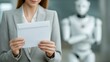 © PixelVision - Close-up of a woman in a business suit holding a layoff letter in a modern office with a robotic figure in the background and soft lighting in the early afternoon