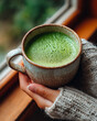 © aboutnuylove - Woman's hands holding a cup of matcha latte on the window