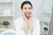 © Shisu_ka - Beautiful Asian woman smile use cream for good skin. face of a healthy woman apply cream and makeup. Advertisement for skin cream, anti-wrinkle, baby face, whitening, moisturizer, tighten pores serum