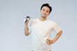 © Freddy Chandra - young asian man holding controller in studio background