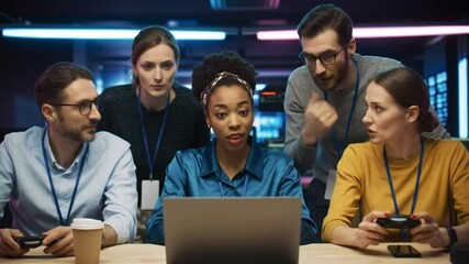 Diverse team collaborating on gaming and software development in a modern office