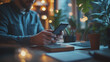 © ganlaya - a man using smartphone for business planning in the morning