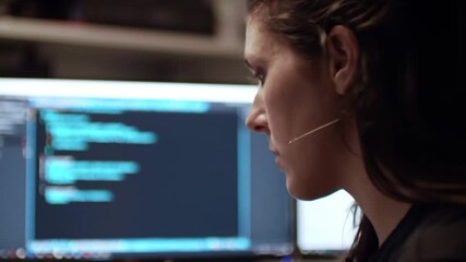 Focused cybersecurity expert analyzing complex code on a glowing computer screen