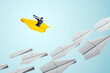 © Who is Danny - Businessman leading with vision on yellow paper plane among white planes on light background, symbolizing leadership and future strategy.